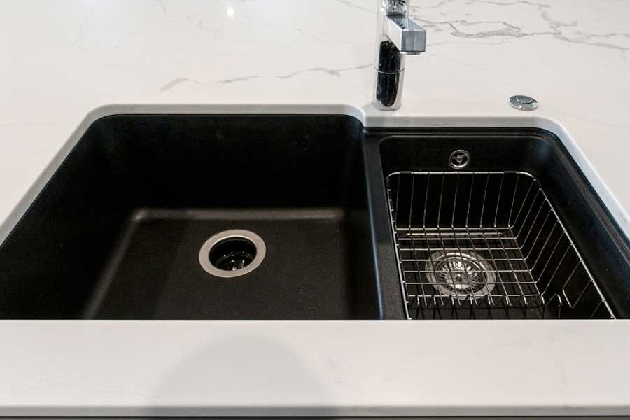 Black sink set into white stone